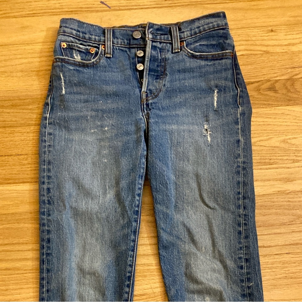 Levi's Women's straight leg jeans, medium wash blue with mild distressing